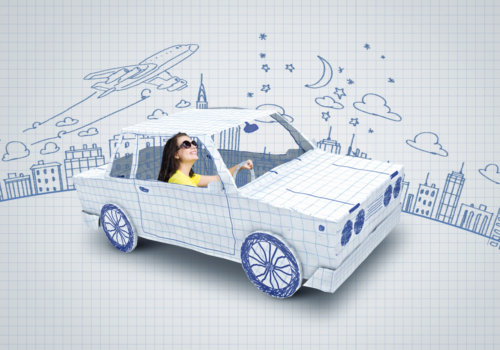 Young woman riding car made of list of paper